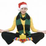 Happy woman wearing holiday clothes doing yoga