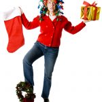 Overwhelmed woman balancing holiday decorations and gifts