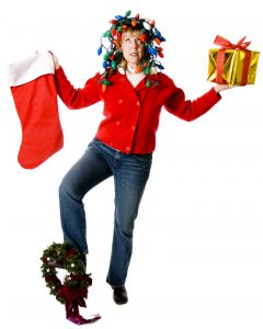 Overwhelmed woman balancing holiday decorations and gifts